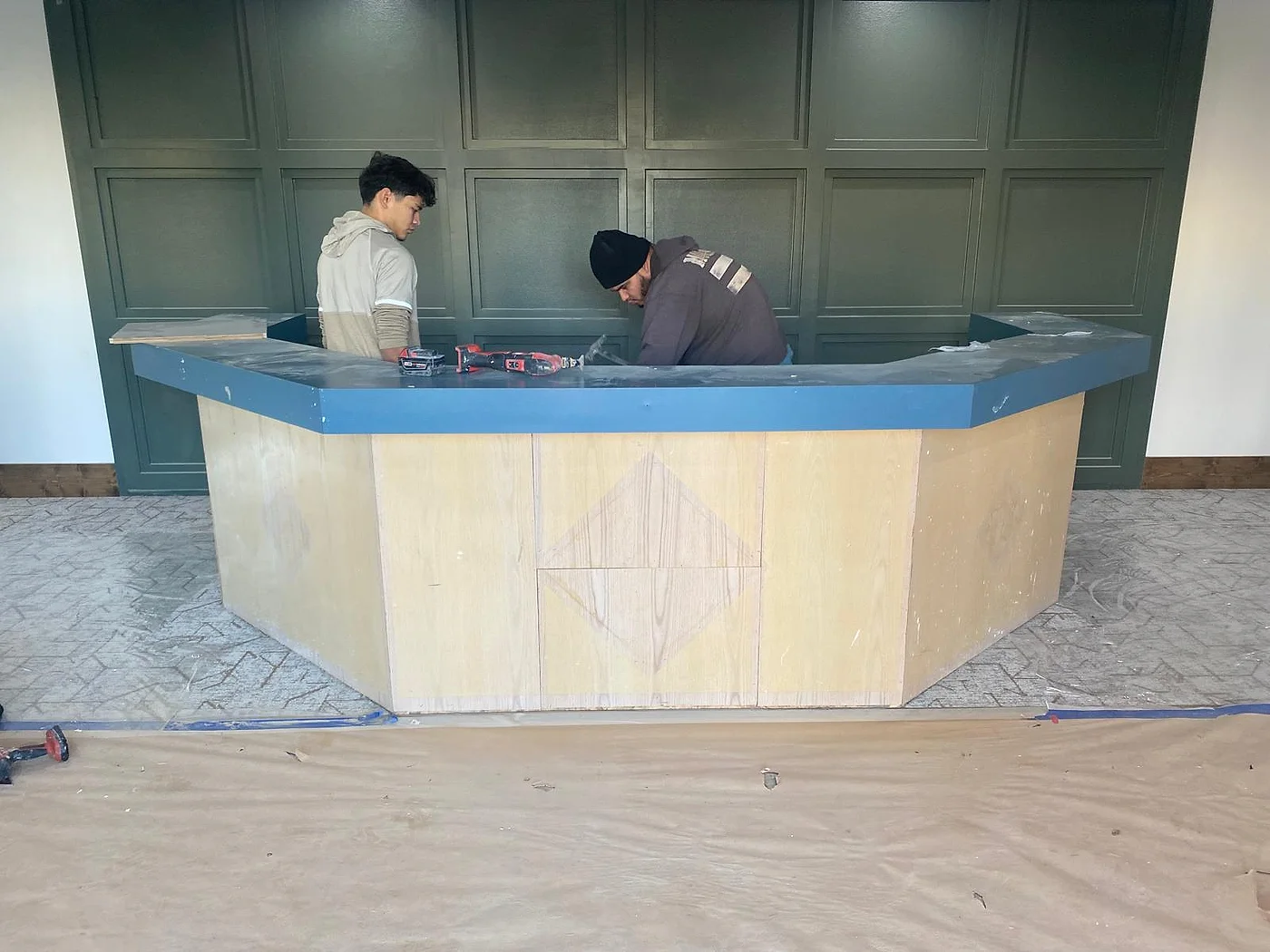 Angular bar under construction — framed plywood base before the stone top is set